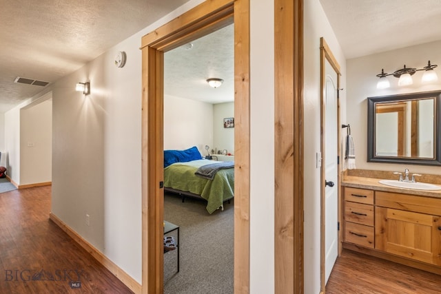 205 Water St, Sheridan, MT 59749 - corridor featuring wood finished floors and a textured ceiling