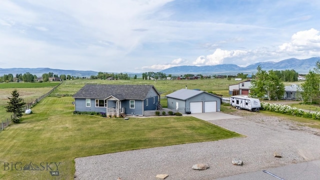 191 Barnes Dr, Belgrade, MT 59714 - single story home featuring a detached garage, a mountain view, and an outdoor structure