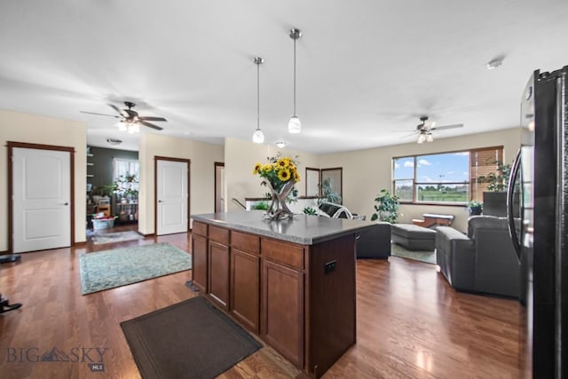 191 Barnes Dr, Belgrade, MT 59714 - kitchen with ceiling fan, freestanding refrigerator, open floor plan, and a kitchen island