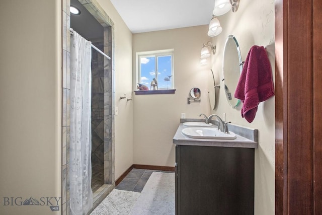 191 Barnes Dr, Belgrade, MT 59714 - bathroom with double vanity, tiled shower, and tile patterned flooring