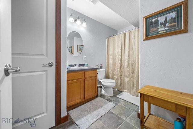 191 Barnes Dr, Belgrade, MT 59714 - bathroom with vanity, stone finish flooring, a shower with shower curtain, and a textured wall