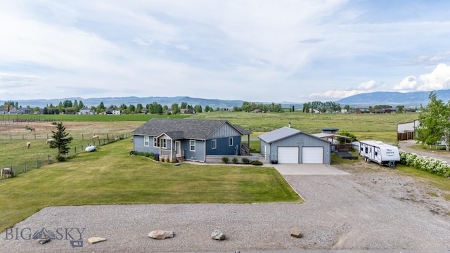 191 Barnes Dr, Belgrade, MT 59714 - view of front facade featuring an outdoor structure, a mountain view, a view of countryside, and driveway