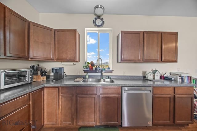 191 Barnes Dr, Belgrade, MT 59714 - kitchen featuring dishwasher, dark countertops, and brown cabinetry