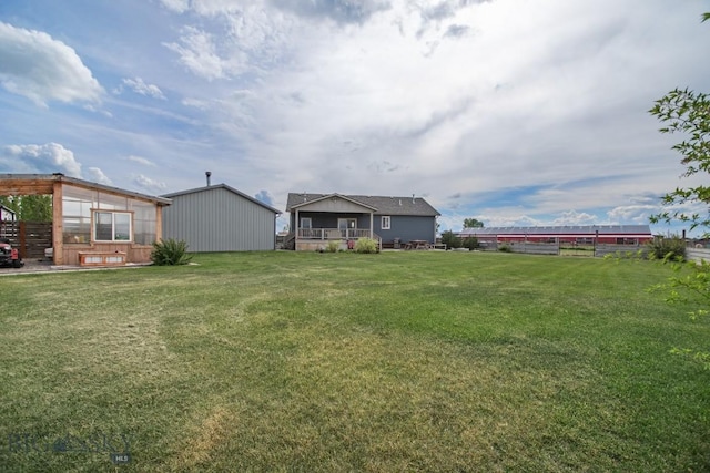191 Barnes Dr, Belgrade, MT 59714 - view of yard featuring a wooden deck and an outbuilding