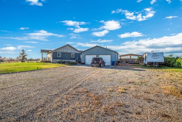 191 Barnes Dr, Belgrade, MT 59714 - view of front of property with driveway, an outdoor structure, and board and batten siding