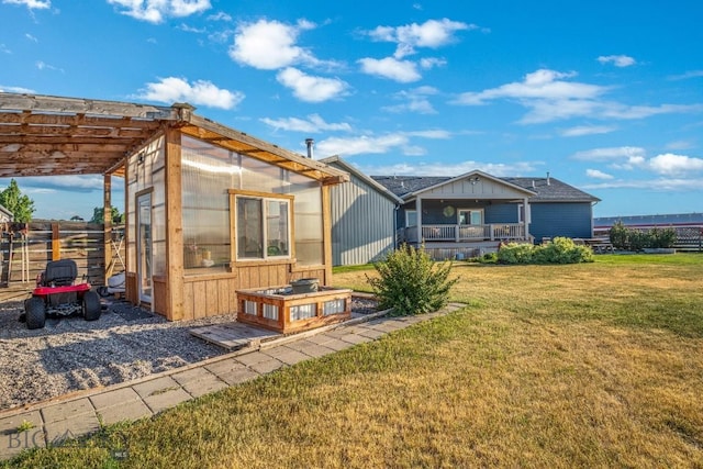191 Barnes Dr, Belgrade, MT 59714 - rear view of house featuring an exterior structure, an outbuilding, and a pergola