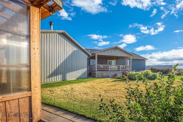 191 Barnes Dr, Belgrade, MT 59714 - rear view of house featuring a yard and board and batten siding