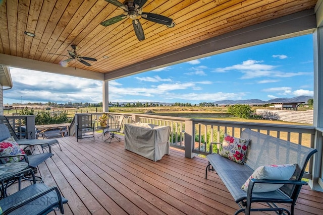 191 Barnes Dr, Belgrade, MT 59714 - wooden deck featuring a ceiling fan, a rural view, and a mountain view