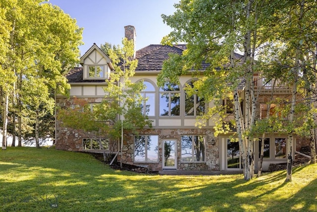 2421 Highland Blvd, Bozeman, MT 59715 - rear view of property with a yard, stone siding, stucco siding, and a chimney