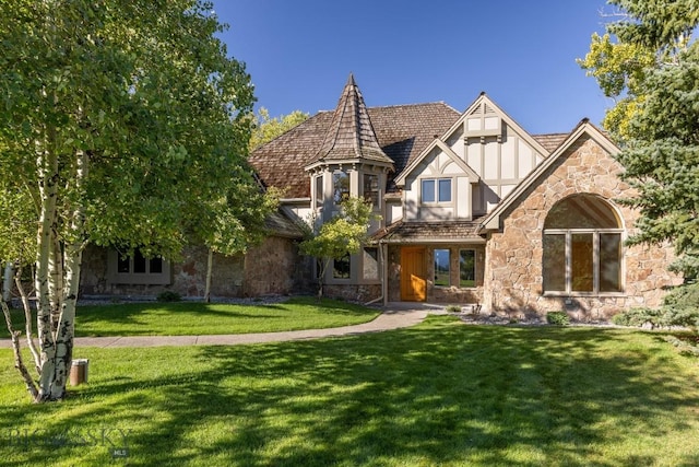 2421 Highland Blvd, Bozeman, MT 59715 - tudor-style house featuring stone siding, a front yard, and stucco siding