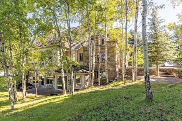 2421 Highland Blvd, Bozeman, MT 59715 - rear view of property with a yard, stone siding, a patio area, and stucco siding