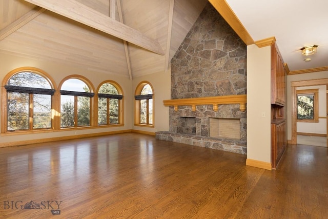 2421 Highland Blvd, Bozeman, MT 59715 - unfurnished living room featuring a fireplace, wood finished floors, baseboards, plenty of natural light, and beam ceiling