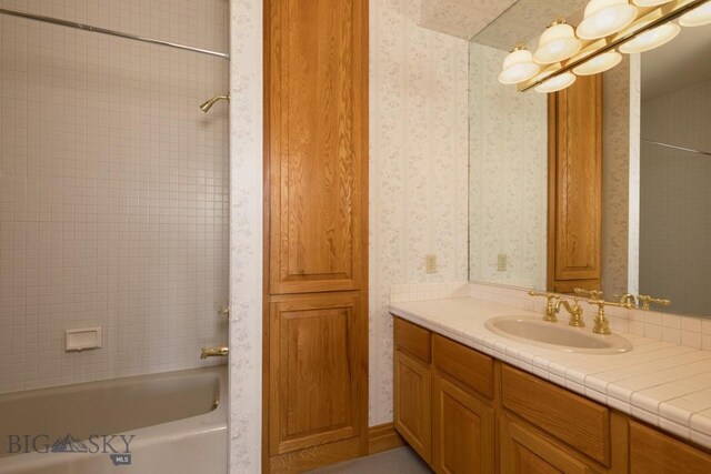2421 Highland Blvd, Bozeman, MT 59715 - bathroom with wallpapered walls, vanity, and bathtub / shower combination