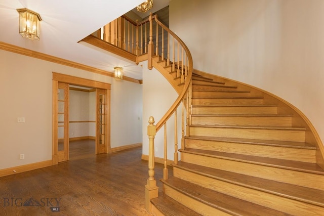 2421 Highland Blvd, Bozeman, MT 59715 - staircase featuring crown molding, wood finished floors, baseboards, and a chandelier
