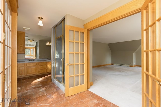 2421 Highland Blvd, Bozeman, MT 59715 - full bathroom featuring baseboard heating, vanity, a shower stall, vaulted ceiling, and baseboards