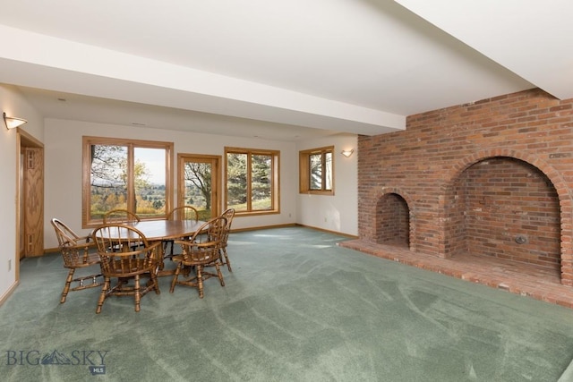 2421 Highland Blvd, Bozeman, MT 59715 - dining space featuring baseboards, carpet, a fireplace, and brick wall