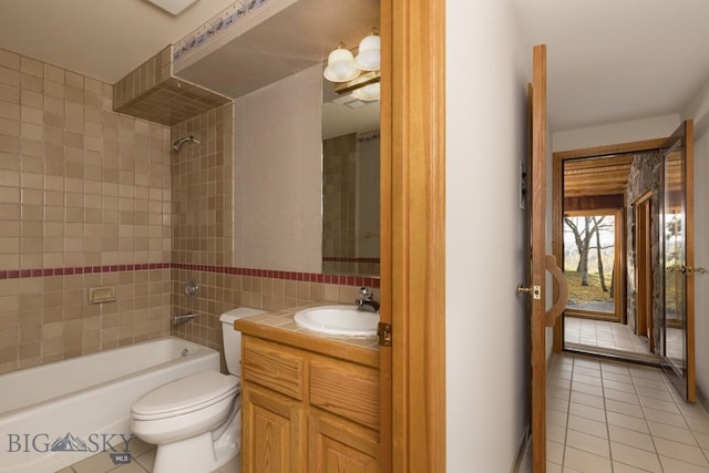 2421 Highland Blvd, Bozeman, MT 59715 - bathroom with tile patterned flooring, vanity, tub / shower combination, toilet, and tile walls
