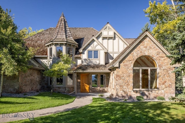 2421 Highland Blvd, Bozeman, MT 59715 - tudor-style house featuring stone siding, a front yard, and stucco siding