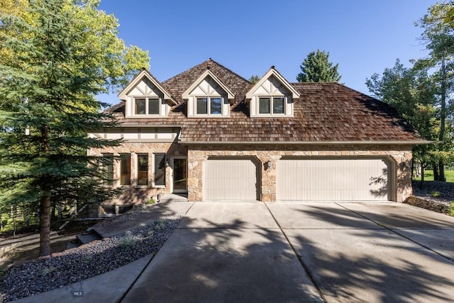 2421 Highland Blvd, Bozeman, MT 59715 - view of front of home with stone siding, concrete driveway, and a garage