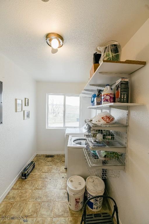 2373 Mt Highway 278, Dillon, MT 59725 - washroom with independent washer and dryer, baseboards, a textured ceiling, and tile patterned floors