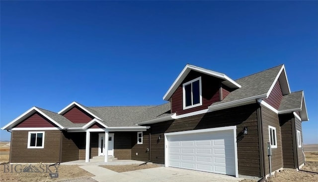 17 Durango Trl, Three Forks, MT 59752 - view of front facade with a garage, concrete driveway, and roof with shingles