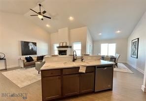 17 Durango Trl, Three Forks, MT 59752 - kitchen featuring stainless steel dishwasher, open floor plan, light countertops, baseboards, and a kitchen island with sink