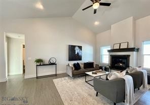 17 Durango Trl, Three Forks, MT 59752 - living room with a ceiling fan, wood finished floors, high vaulted ceiling, a fireplace, and baseboards