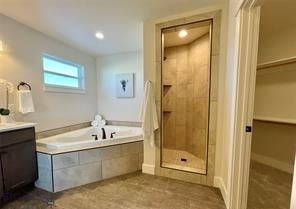 17 Durango Trl, Three Forks, MT 59752 - full bath with vanity, a shower stall, a garden tub, a walk in closet, and recessed lighting