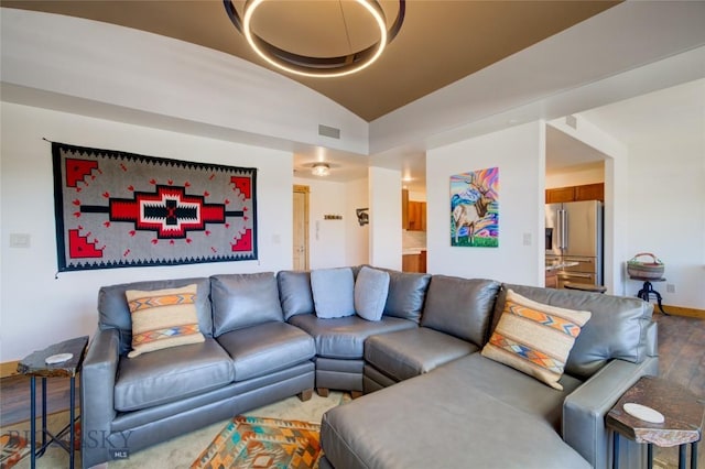 424 E Main St Unit E, Bozeman, MT 59715 - living room featuring vaulted ceiling, wood finished floors, and baseboards