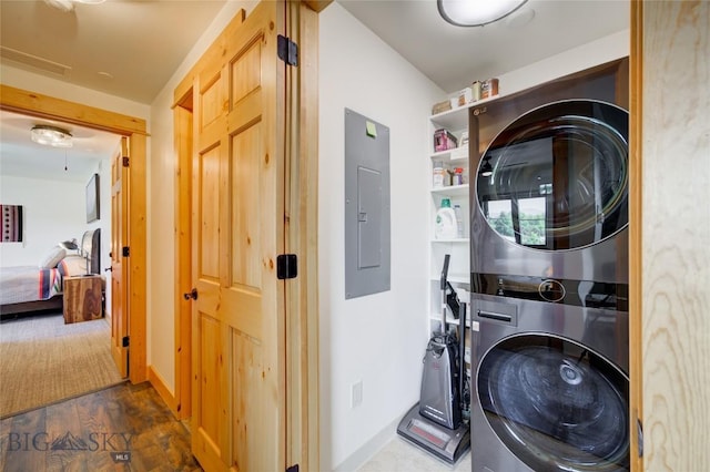 424 E Main St Unit E, Bozeman, MT 59715 - laundry area with estacked washer and dryer, electric panel, dark wood-style flooring, attic access, and baseboards