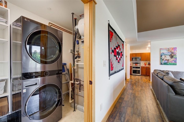 424 E Main St Unit E, Bozeman, MT 59715 - laundry room with stacked washing machine and dryer, wood finished floors, and baseboards