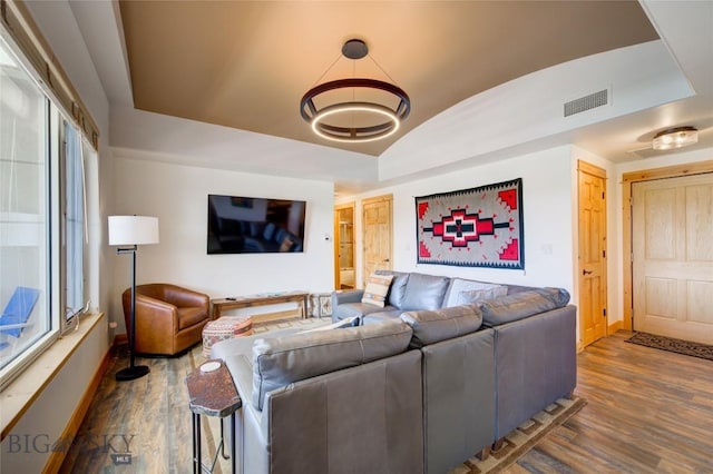 424 E Main St Unit E, Bozeman, MT 59715 - living area featuring baseboards, dark wood-style flooring, vaulted ceiling, and a chandelier