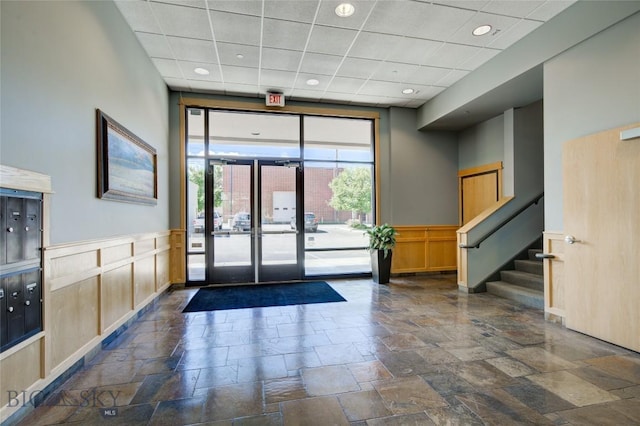 424 E Main St Unit E, Bozeman, MT 59715 - common area featuring a paneled ceiling, wainscoting, stairway, and a decorative wall