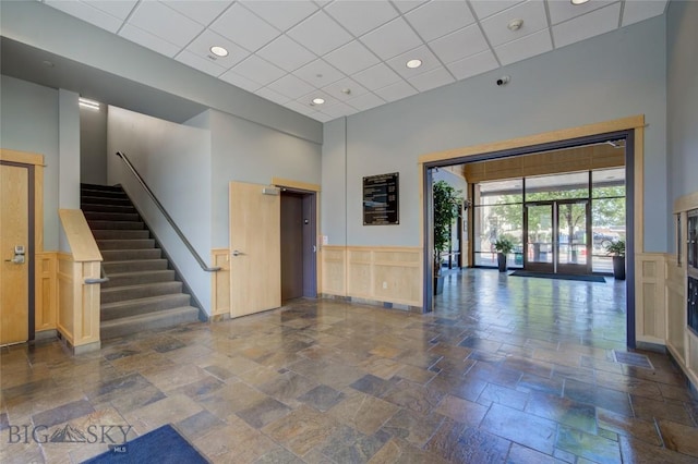 424 E Main St Unit E, Bozeman, MT 59715 - community lobby with a decorative wall, a wainscoted wall, stairway, a high ceiling, and a paneled ceiling