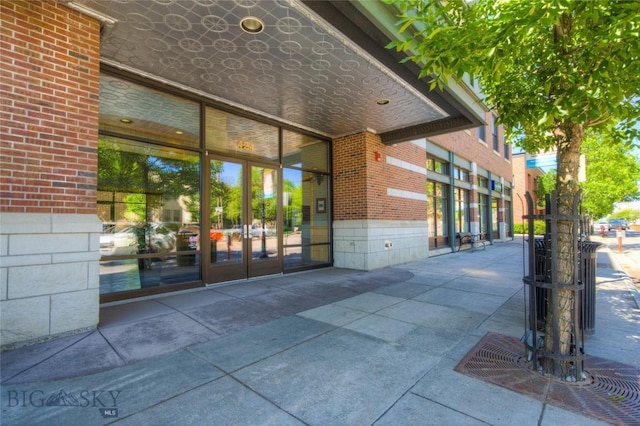 424 E Main St Unit E, Bozeman, MT 59715 - view of exterior entry featuring brick siding, french doors, and a gate