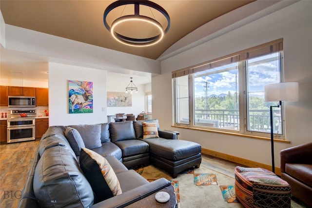 424 E Main St Unit E, Bozeman, MT 59715 - living area with light wood-style floors, baseboards, and vaulted ceiling