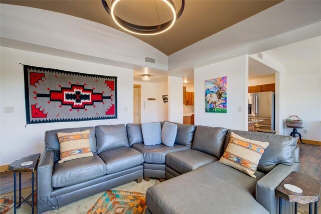 424 E Main St Unit E, Bozeman, MT 59715 - living room featuring vaulted ceiling, wood finished floors, and baseboards