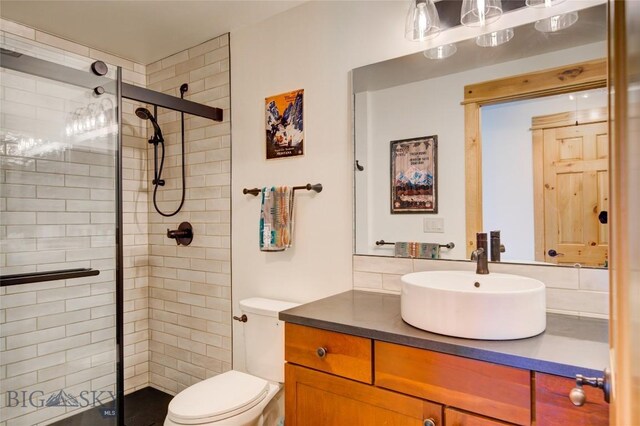 424 E Main St Unit E, Bozeman, MT 59715 - bathroom with a tile shower, vanity, and toilet