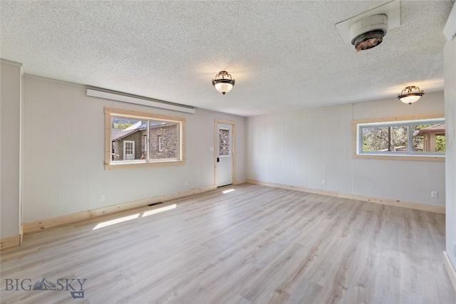 312 Water St, Gardiner, MT 59030 - spare room with wood finished floors, baseboards, and a textured ceiling
