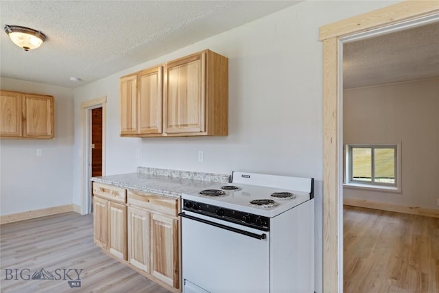 312 Water St, Gardiner, MT 59030 - kitchen featuring electric stove, light brown cabinetry, light wood-style flooring, and a textured ceiling