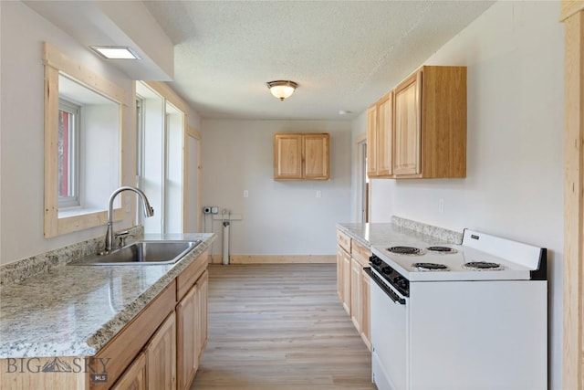 312 Water St, Gardiner, MT 59030 - kitchen featuring white electric range, a sink, light wood finished floors, a textured ceiling, and light countertops