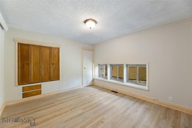 312 Water St, Gardiner, MT 59030 - spare room with wood finished floors, a textured ceiling, baseboards, and crown molding