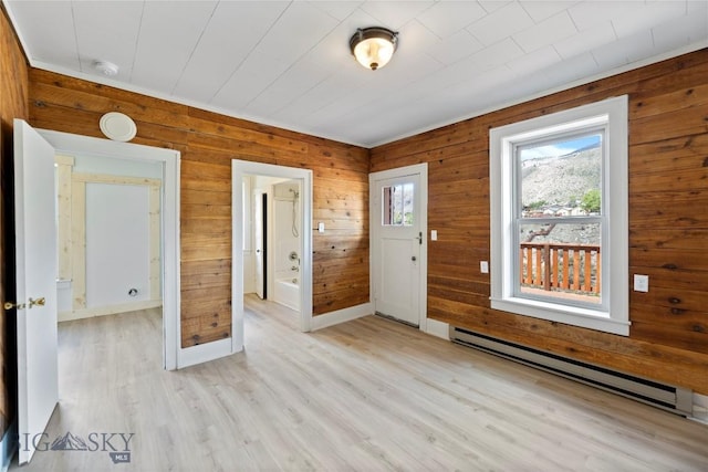 312 Water St, Gardiner, MT 59030 - foyer featuring a baseboard radiator, wooden walls, and light wood-type flooring