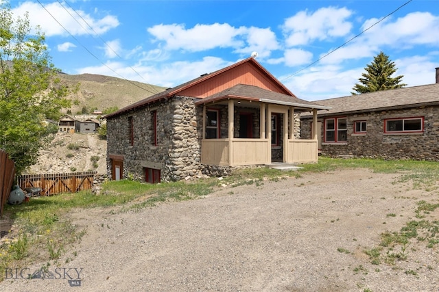 504 4th St, Gardiner, MT 59030 - view of front of property featuring stone siding and a mountain view