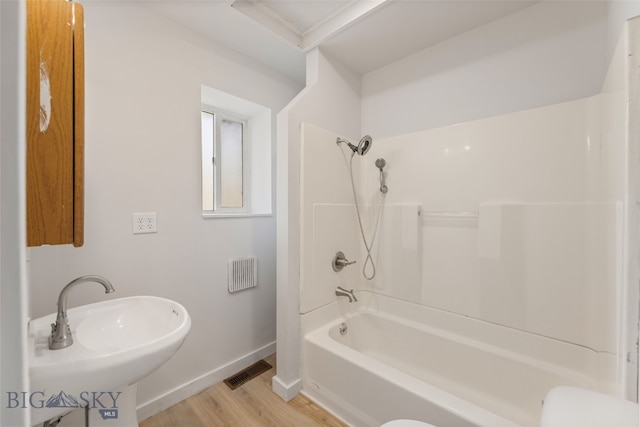 504 4th St, Gardiner, MT 59030 - bathroom featuring wood finished floors and shower / bath combination