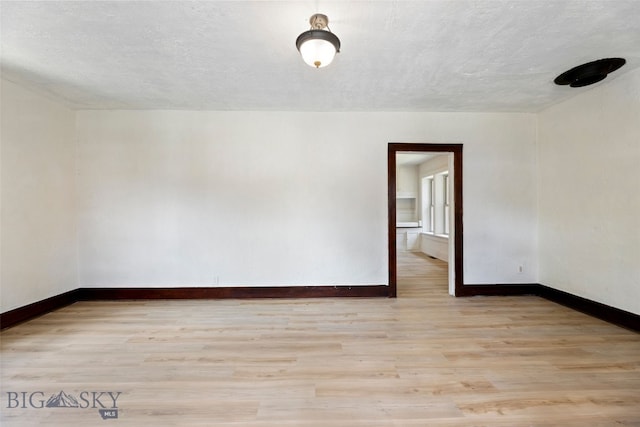 504 4th St, Gardiner, MT 59030 - unfurnished room featuring light wood-style flooring and a textured ceiling