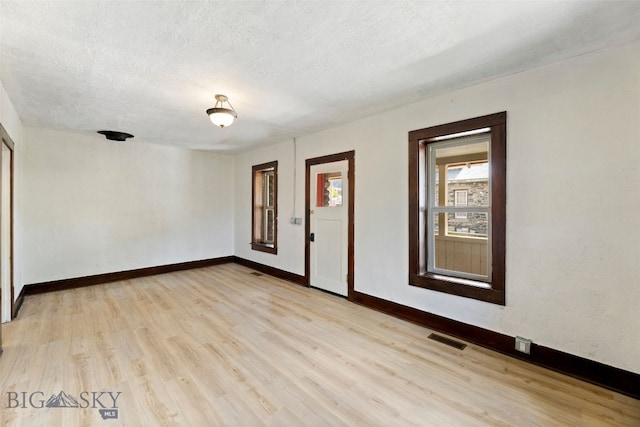 504 4th St, Gardiner, MT 59030 - spare room featuring light wood-style floors and a textured ceiling
