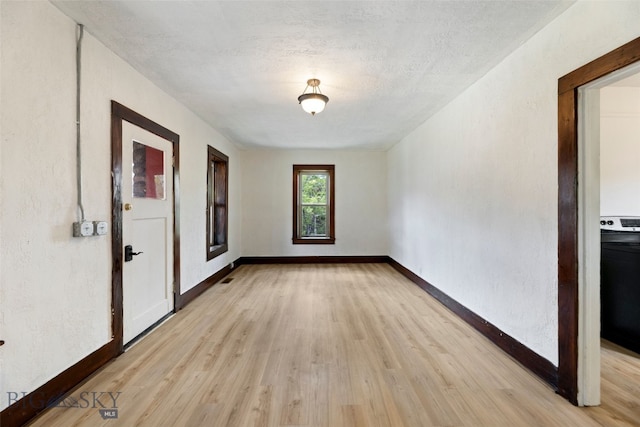 504 4th St, Gardiner, MT 59030 - empty room with light wood-type flooring, baseboards, and washer / dryer