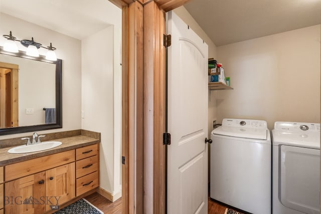 205 Water St, Sheridan, MT 59749 - laundry area featuring a sink, washing machine and clothes dryer, and wood finished floors