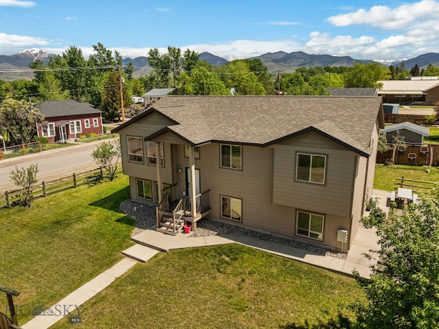 205 Water St, Sheridan, MT 59749 - back of house featuring a mountain view, roof with shingles, and a patio area